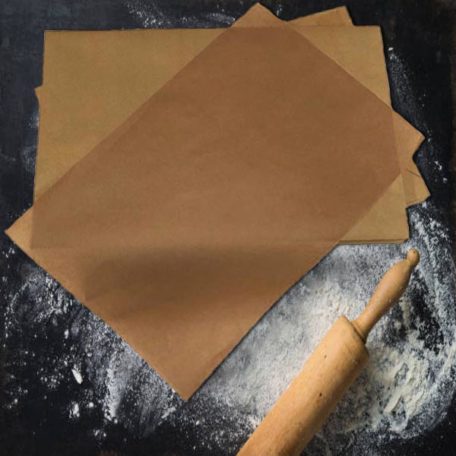 Baking background with the rolling pin and flour. On the dark table. Copy space for text. Top view